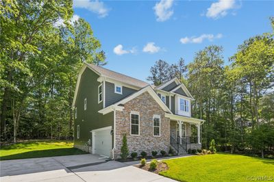 Craftsman inspired home featuring a garage and a front lawn | Image 2