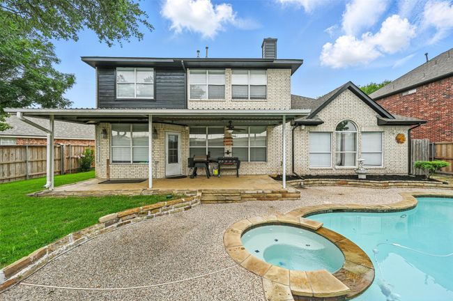 Rear view of property with brick siding, a patio, a fenced backyard, and a chimney | Image 29