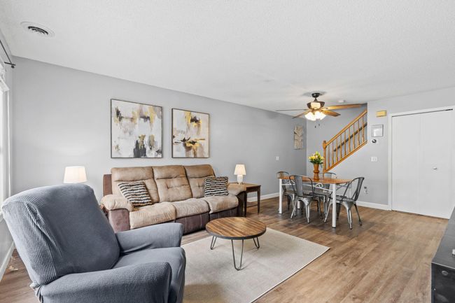 Bright and open living and dining area with updated flooring and neutral tones throughout. | Image 6
