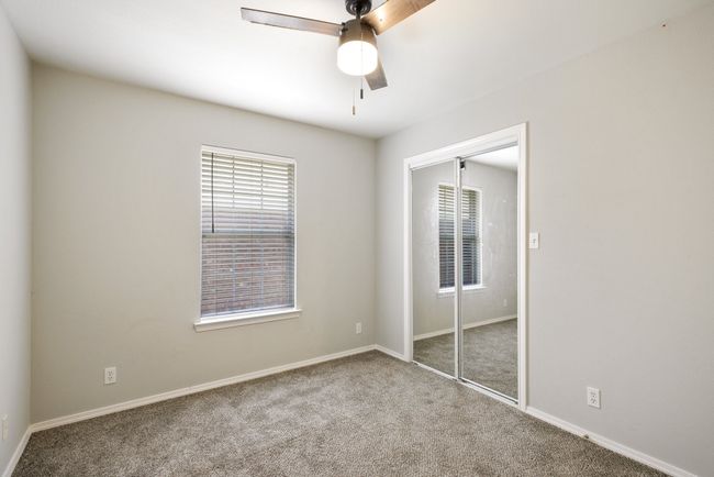 Unfurnished bedroom with a closet, carpet, and a ceiling fan | Image 22