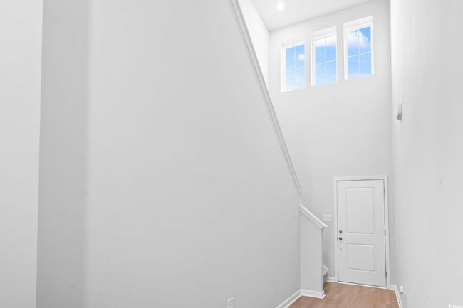Stairway featuring wood finished floors and baseboards | Image 10