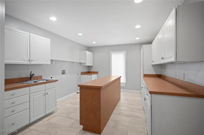 Laundry Room with a center island, recessed lighting, and white cabinets | Image 31