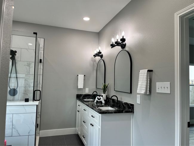Bathroom featuring double vanity, a shower stall, and tile patterned flooring | Image 26