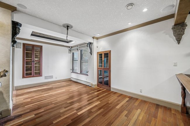 The sitting area includes a custom humidor, as well as a projector screen that pulls down from the ceiling. The entertainment unit on the right side of the photo rolls out to allow for access to the wiring. The unit is wired for surround sound! | Image 5