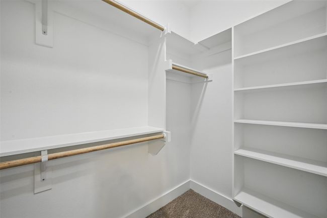 Spacious closet with dark colored carpet | Image 16