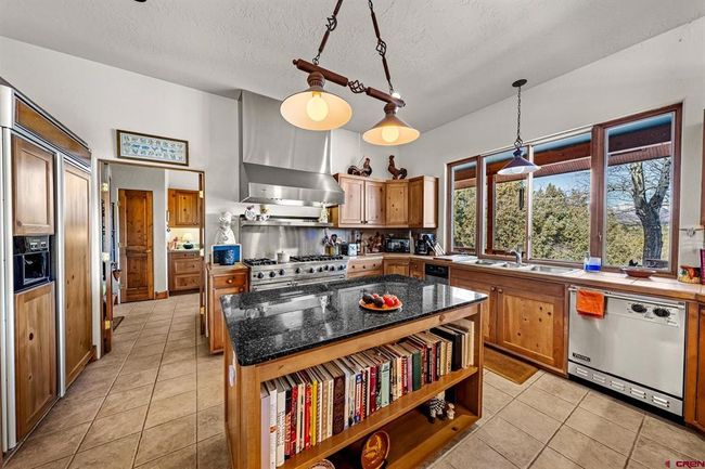 Kitchen includes a 6-burner Viking stove with dual convection ovens. | Image 12