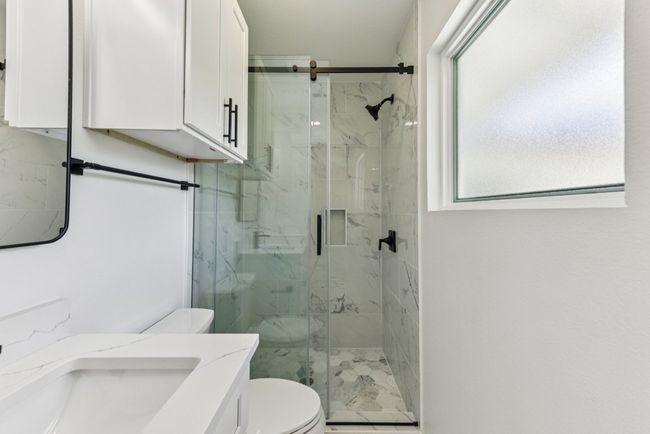 Full bathroom with a marble finish shower and vanity | Image 22