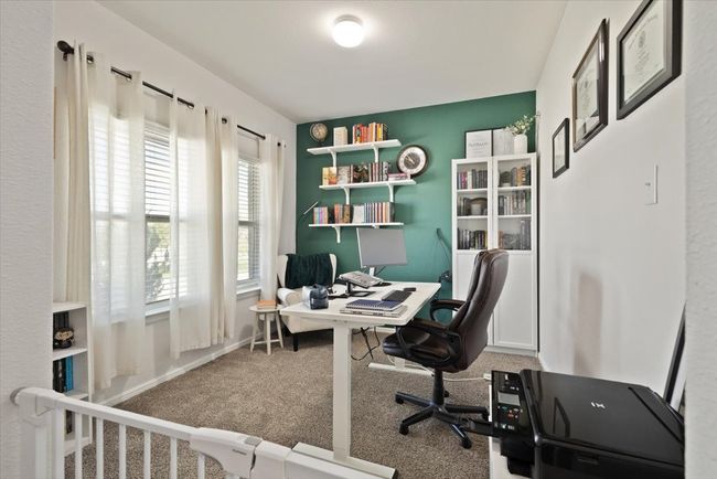 Office space featuring decorated accent wall and carpet flooring | Image 5