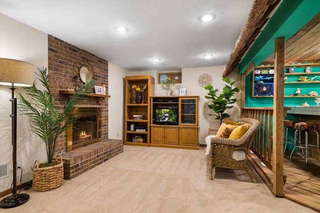 Lower level living space with woodburning fireplace | Image 20