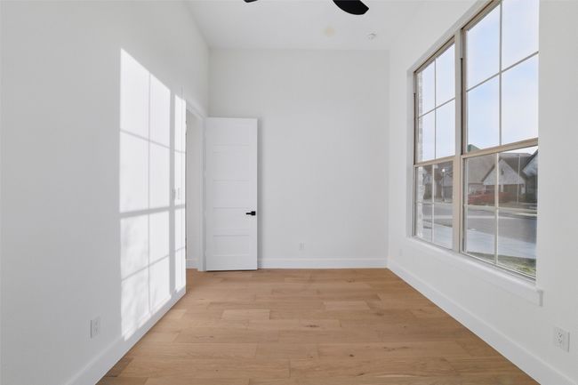 Unfurnished room featuring baseboards, light wood-style floors, and a ceiling fan | Image 15