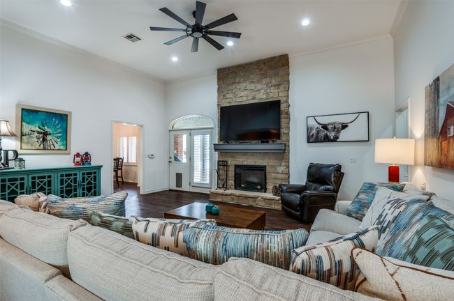 Living room featuring crown molding, a fireplace, a ceiling fan, and recessed lighting | Image 7