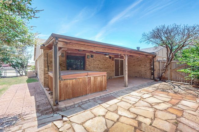 View of patio with a hot tub and a gate | Image 18