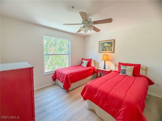 Bedroom with ceiling fan, baseboards, and wood finished floors | Image 42