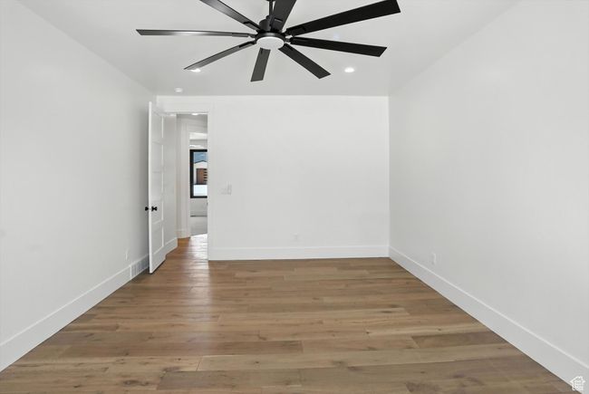 Spare room with ceiling fan, light wood finished floors, and recessed lighting | Image 29