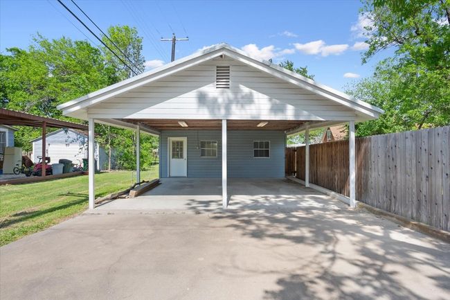 View of front of property with concrete driveway, fence, and a front lawn | Image 35