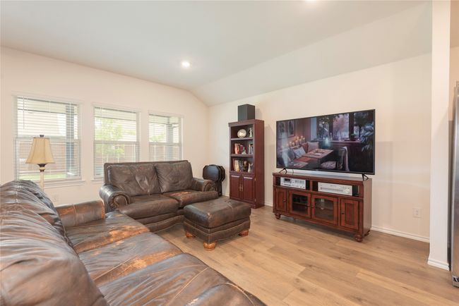 Living area featuring vaulted ceiling, light wood-style floors, and recessed lighting | Image 19