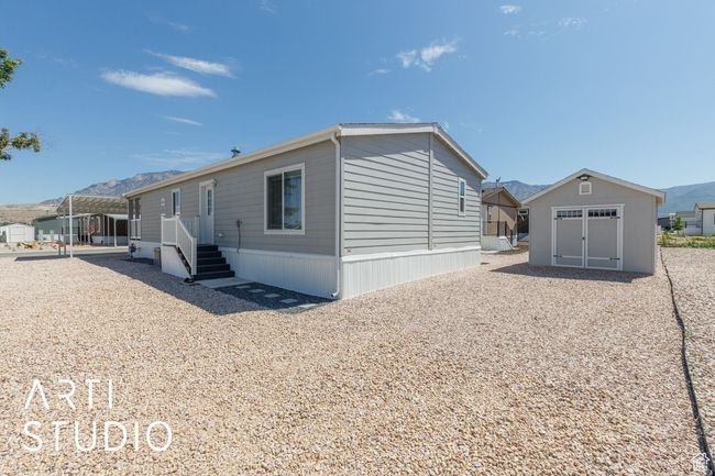 Back of property featuring a mountain view and a shed | Image 22