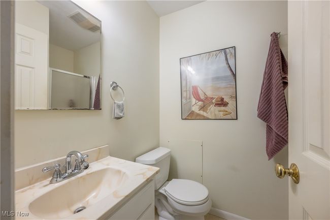 Bathroom with a stall shower, visible vents, toilet, and vanity | Image 29