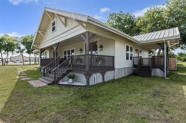 View of front of house featuring a front lawn and metal roof | Image 4