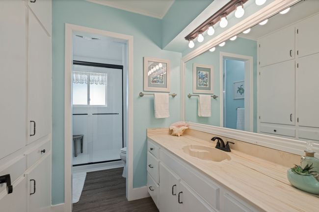 Full bath with vanity, a shower stall, ornamental molding, and wood finished floors | Image 30