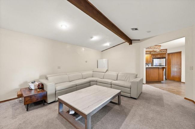Living area with light colored carpet and baseboards | Image 17