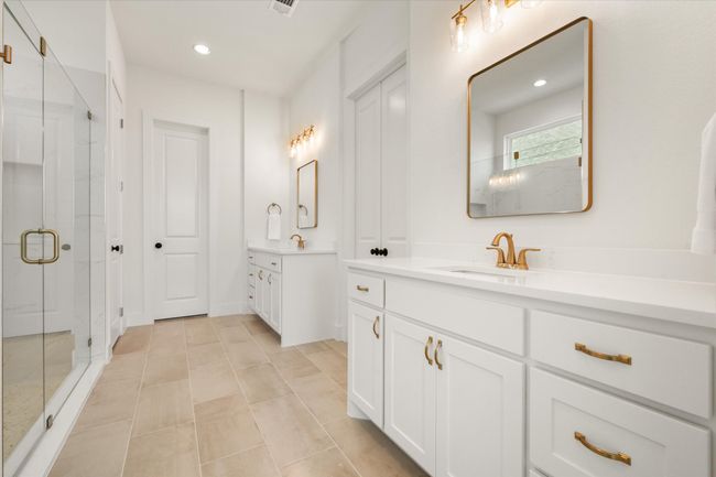 Primary Bathroom has oversized walk in shower as well as two full sized closets with one having access to the laundry room. | Image 5