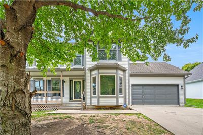 View of front facade featuring a porch and a garage | Image 3