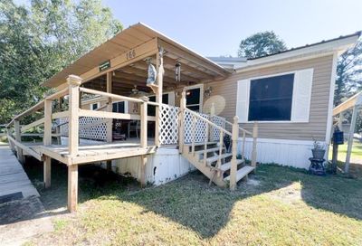 The home features a spacious covered front porch with railings and lattice privacy panels, perfect for outdoor relaxation. | Image 2