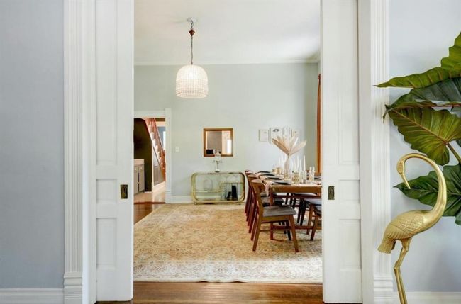 Dining area with wood finished floors and crown molding | Image 7