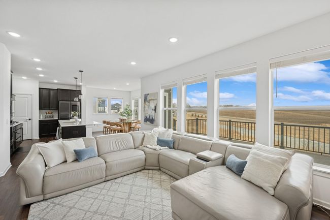 The main floor living room is flooded with natural light. | Image 6