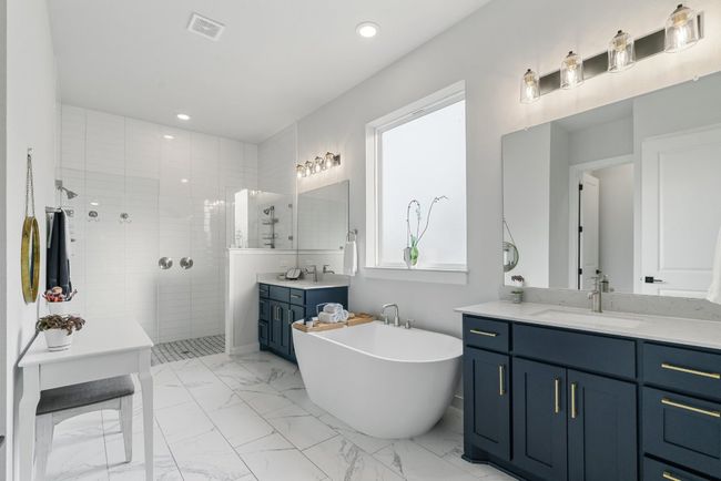 Full bathroom with tiled shower, two vanities, a soaking tub, marble finish floors, and recessed lighting | Image 22