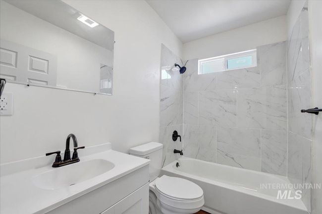 Bathroom with vanity and tub / shower combination | Image 23