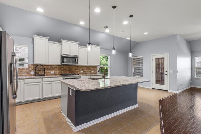Enjoy granite countertops, ss appliances, gas cooktop, and large island | Image 12