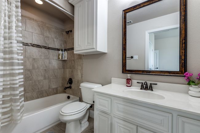 Full bathroom featuring shower / bath combo, vanity, and tile patterned floors | Image 21