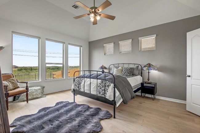 Bedroom featuring light wood-style floors, high vaulted ceiling, and a ceiling fan | Image 17