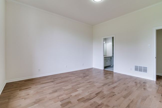 Spare room featuring light wood-type flooring, ornamental molding, and baseboards | Image 11