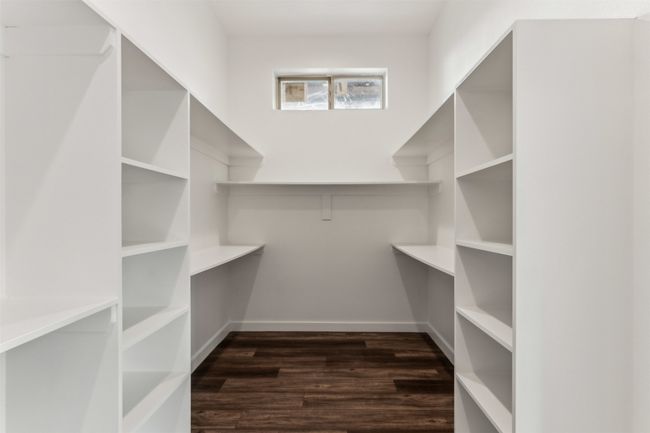 Walk in closet featuring dark wood-type flooring | Image 33