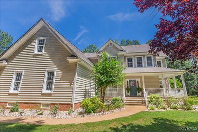 View of front of home with covered porch and a front lawn | Image 2