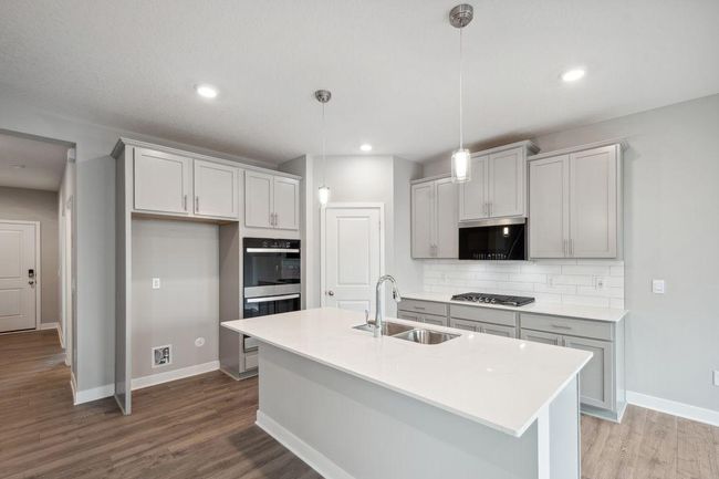 A stunning kitchen layout, all while remaining remarkably functional. Photos used are from a model of a similar plan/home representation. Some colors and options will vary. | Image 4