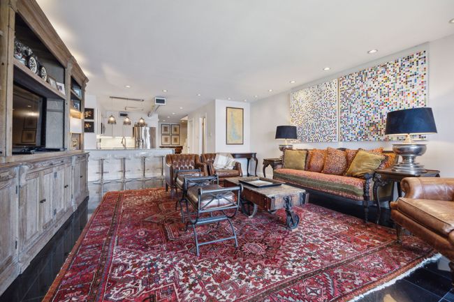 Spacious living area with fireplace, looking at kitchen and entryway | Image 17