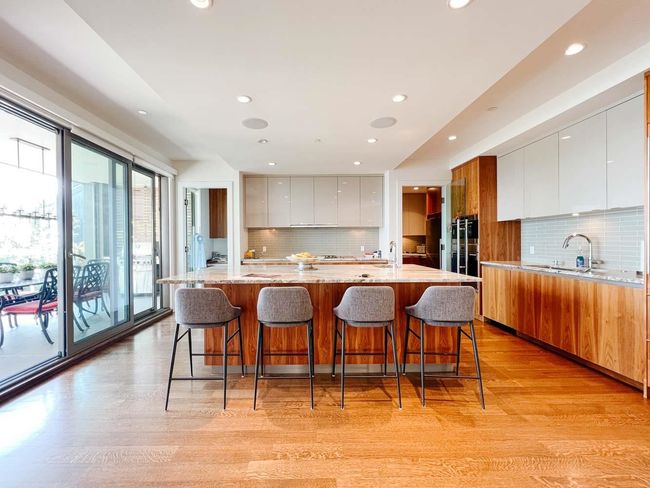 Kitchen with modern cabinets, recessed lighting, tasteful backsplash, light wood finished floors, and a sink | Image 11