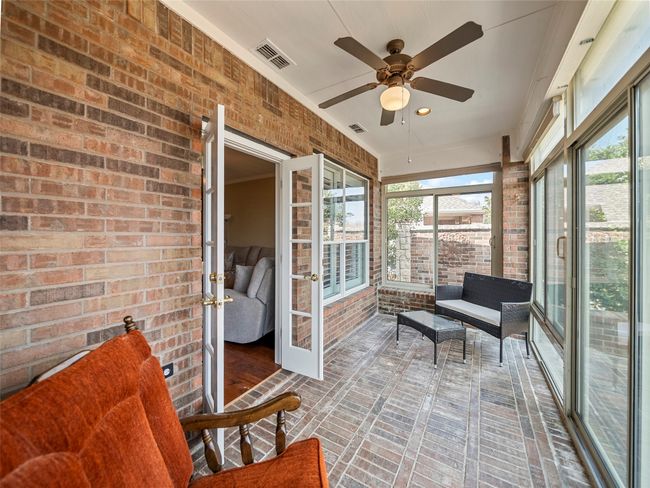 Sunroom featuring a ceiling fan, visible vents, and a healthy amount of sunlight | Image 28