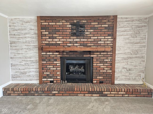 Gas log fireplace located in the living room. | Image 8
