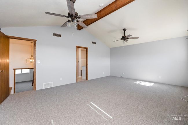 Carpeted empty room featuring a ceiling fan and a smoke detector | Image 20