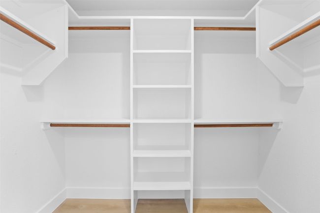 Primary walk in closet featuring custom shelving | Image 23