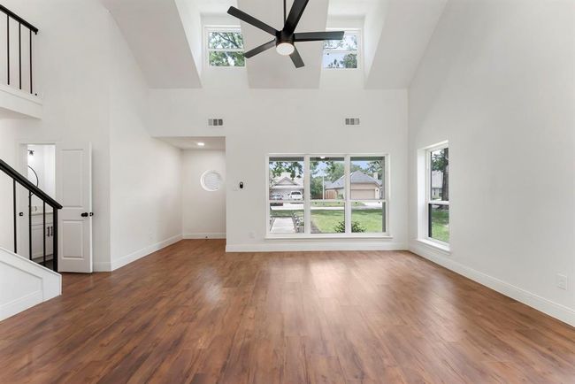 Notice the powder bath conveniently located for guests. Light and bright family room beams with soaring ceilings and luxury vinyl plank flooring. | Image 5