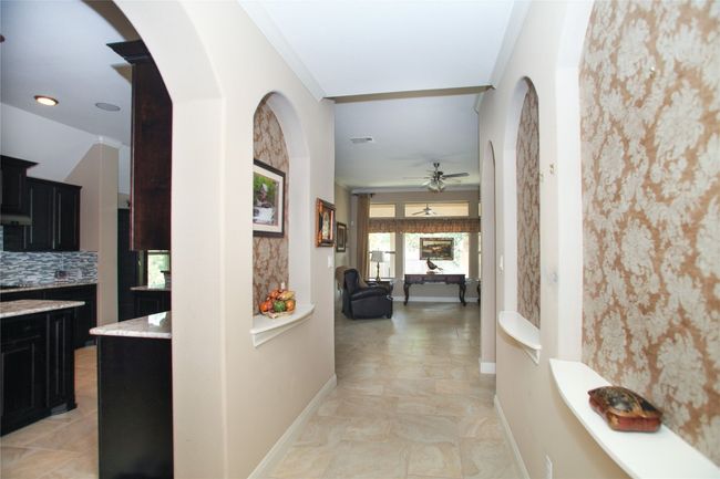 Hallway Corridor lead from the front door to the living room. | Image 32