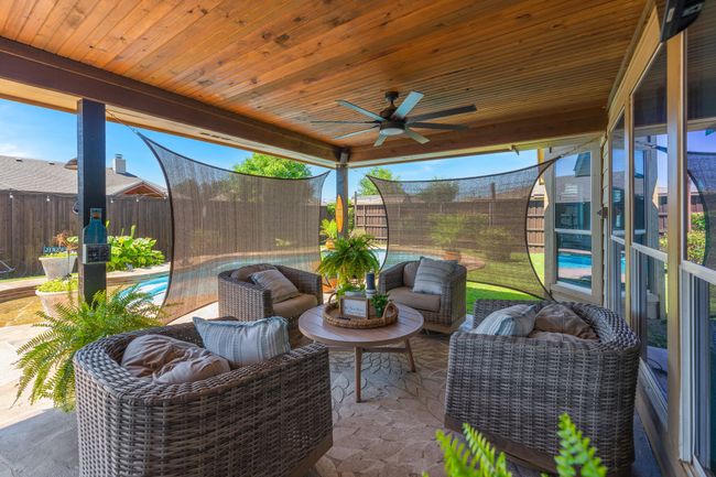 Sunroom featuring ceiling fan and outdoor lounge area | Image 29