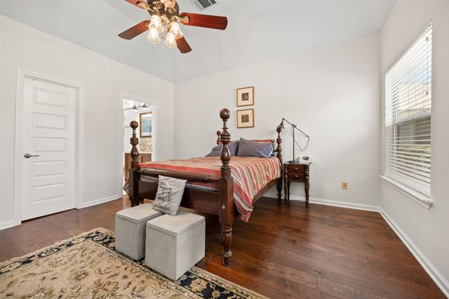 Bedroom featuring hardwood / wood-style flooring and ceiling fan | Image 16