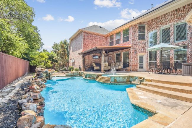 View of swimming pool with a patio and pool water feature | Image 35